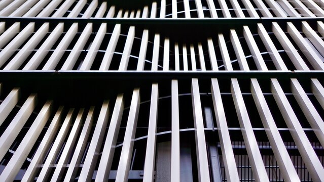 Exterior metal screens in a wave pattern on a building facade
