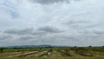 Rolling Hills and Farm Fields Under Cloudy Skies