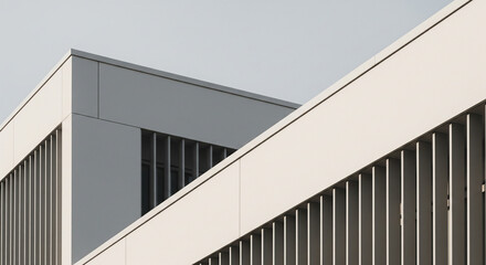 Modern building corner with sleek design and gray accents viewed from below
