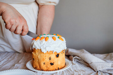 woman cutting homemade Easter cake panettone.