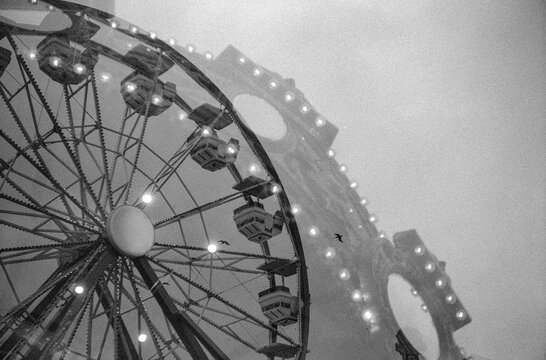 Double exposure film photo of carnival ride and birds