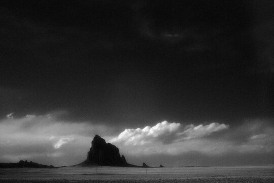Black and white silhouette of jagged rock formation on film
