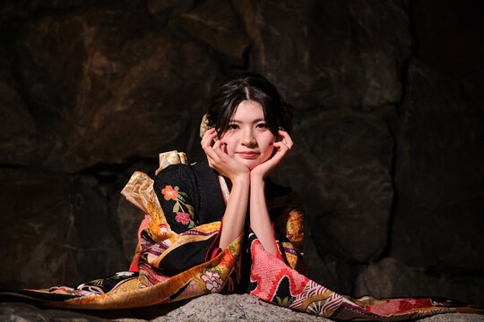 Woman in kimono celebrating Seijin no Hi at night