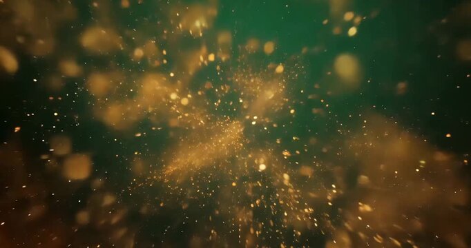 Golden particles exploding in dark green background with sparkling effect Golden particles exploding