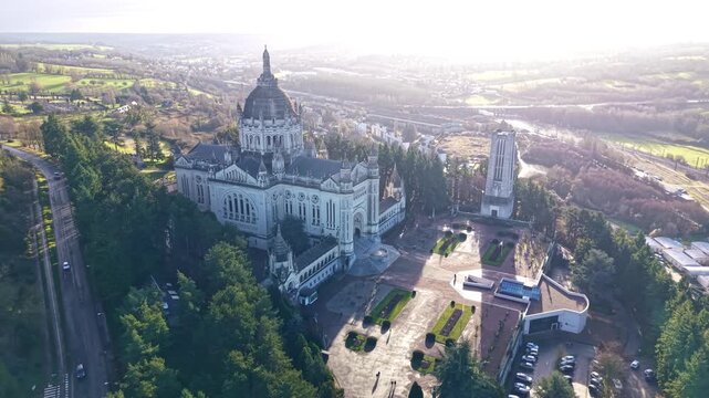 Beautiful distant drone view of the minor Basilica of Sainte-Th&eacute;rese of Lisieux and surrounded landscape, Lisieux, France