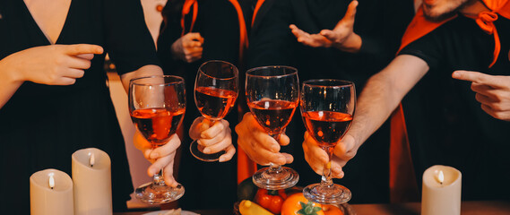 Friends enjoying a Halloween party at a bar making a toast