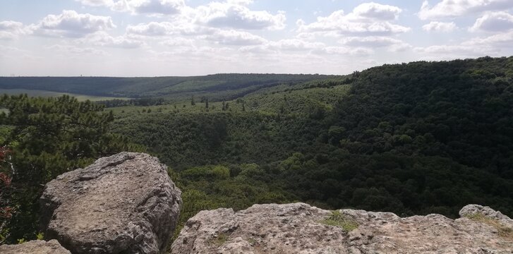 Scenic cliff view over rolling forest hills