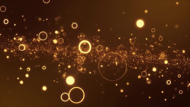 Golden glowing particles and rings float and sparkle in a dark abstract background creating a