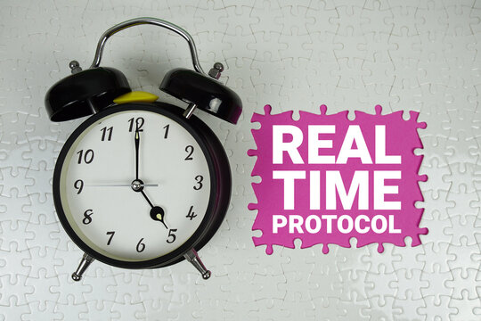 Real Time Protocol (RTP) text with alarm clock on pink background