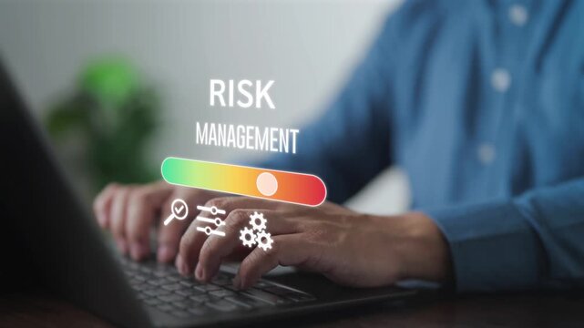 Businessman using laptop with digital risk management dashboard. Concept of financial stability, assessment level meter, insurance, and strategic planning for business security and crisis control.