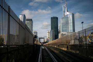 Urban architecture railway tracks transport urban Paris La Defense skyline modern infrastructure with leading lines toward towers in daylight