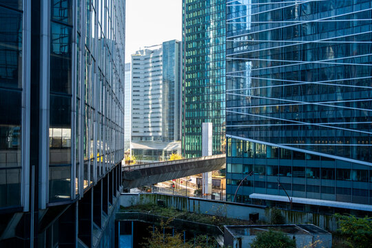 Modern architecture skybridge urban glass office Paris La Defense corporate connection linking towers above the street in a business district