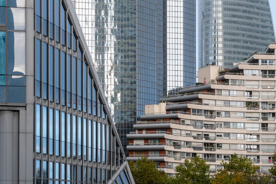 Modern architecture facade office urban Paris La Defense corporate street view with glass buildings and apartments in active financial district