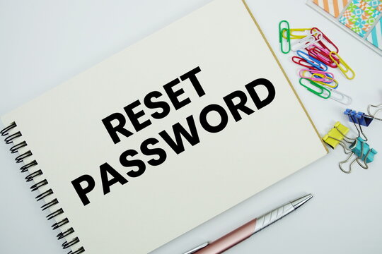 Reset Password text message written on notepad with stationery flat lay on white background