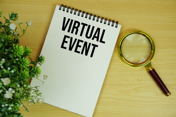 Virtual Event text written on notepad with magnifying glass flat lay on wooden background