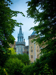 Fairytale turrets of Cardiff Castle in Wales, UK nicely framed by full summer lush tree foliage © Steven F Granville
