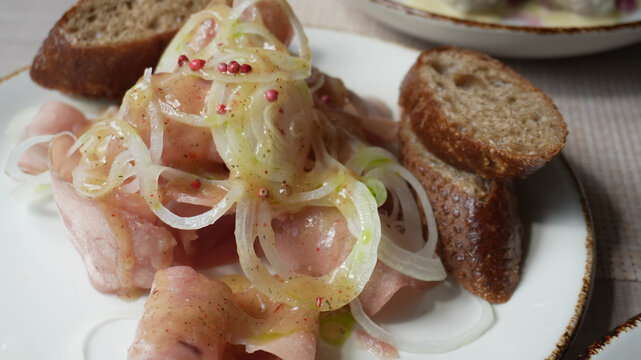 
Stroganina - frozen fish or meat cut into chips, one of the main dishes of northern cuisine, sauce pouring process