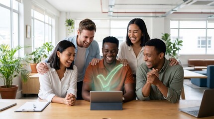 A group of diverse young entrepreneurs laughing and celebrating around a tablet with a green glowing holographic checkmark in a modern office