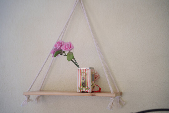 Elegant floral arrangement, Charming pink orchid display, Decorative orchid and book on shelf setup