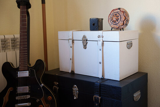 Retro guitar setup, Classic guitar resting among stacked suitcases with mood lighting