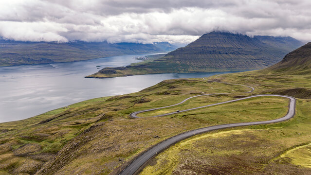 Aerial view of winding coastal road near Rey�arfj�r�ur Iceland with fjord and mountains