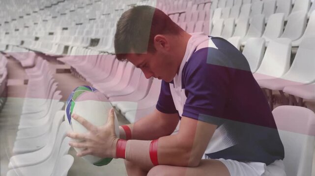 male rugby player leaning forward and inspecting ball, generating overlay showing focus over stands