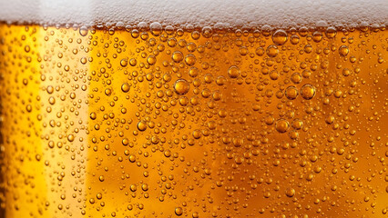 Close-up of frothy beer with bubbles in a clear glass  
