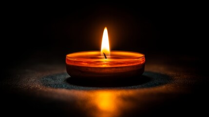 Warm and Soft Glow of a Single Candle Flame Illuminating the Darkness Creating a Peaceful and Serene Atmosphere for Meditation or Relaxation