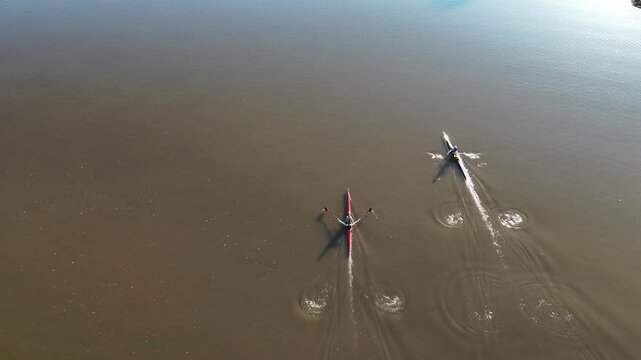 Rowers on sculls in the Fox River., DE Pere, WI, USA