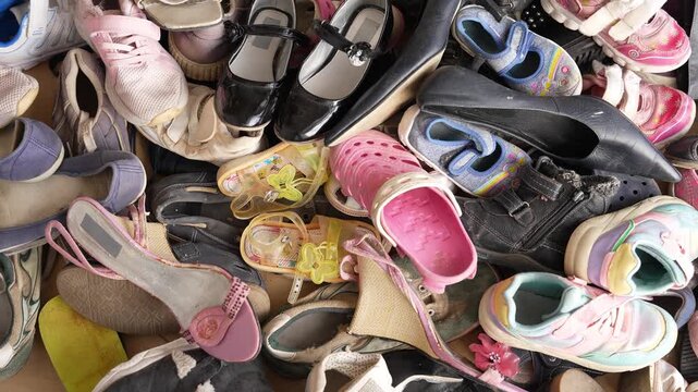 Shoe waste. Pile of old worn shoes waste