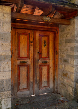 Vintage wooden door in a traditional house in a mountain village in Greece
