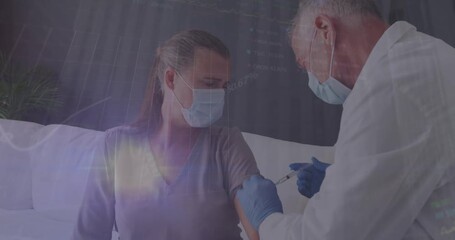 Animation of data processing over caucasian male doctor with face mask vaccinating - Powered by Adobe