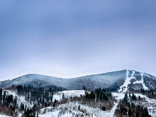Mystical snowy Carpathian peaks under cloudy skies
