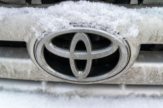 Sosnovy Bor, Russian Federation - December 31, 2025: Toyota logo covered in snow on vehicle front