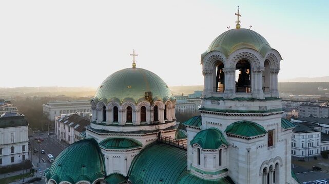 Аerial view of the capital of Bulgaria - Sofia. Iconic building. Close-up and backlight view of the St. Alexander Nevsky Cathedral at sunrise or sunset. The largest church in the Balkans. Movement.