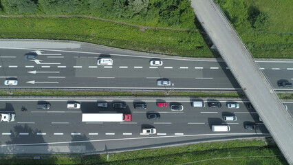 TOP DOWN: Cars and trucks drive through a congestion forming under the overpass. © helivideo