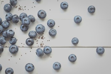 Scattered blueberries on white background