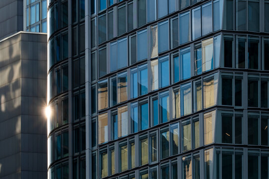 Frankfurt Germany finance business corporate skyscraper architecture office modern downtown closeup of curved glass facade with geometric reflections