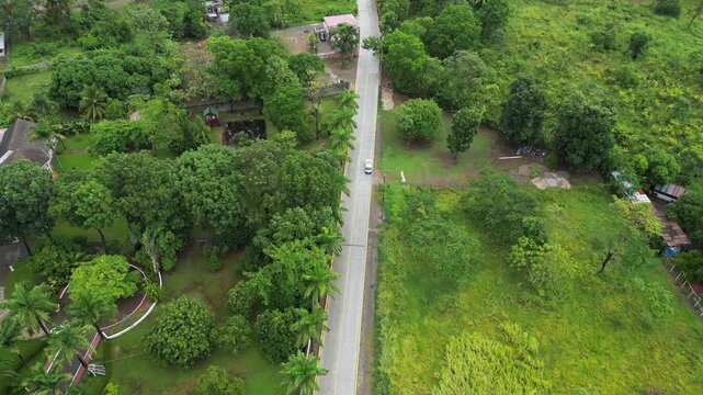 Aerial view of a paved road in a rural community in Arizona, Atlantida, Honduras, improvement in public works