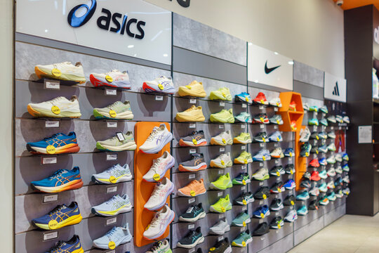 Penang, Malaysia &ndash; December 10, 2025: Athletic footwear from international sports brands is displayed on a feature wall inside a shopping mall.