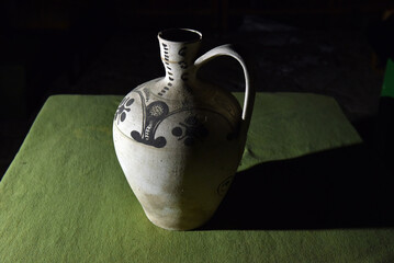 Antique white and black Transylvanian pottery jug made by white clay
