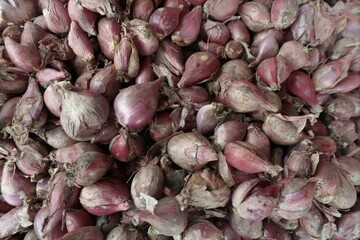 Top View Of Pile Of Fresh Red Shallots With Dry Skins Sold At Traditional Vegetable Market