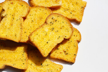 Fototapeta premium Crispy garlic bread slices on white background.
