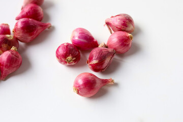 Red shallots on white background.