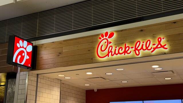 Dulles, VA, USA - 01 09 2026: The illuminated logos of Chick-fil-A on a storefront.