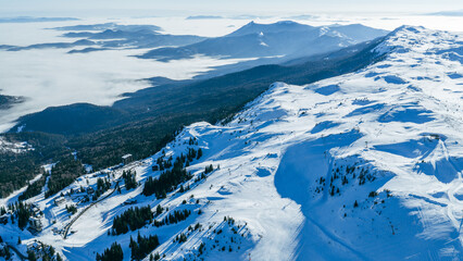 Wide aerial view of Jahorina mountain landscape with snowy slopes, alpine terrain, and visible ski areas forming a well known winter sports destination