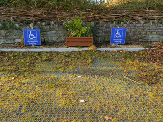 Fototapeta premium Wheel chair space in a parking lot with wheel chair accessible sign. Special place allocated to help people and their families in a public place.