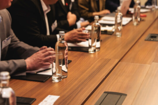 Diplomatic delegation meeting negotiation, group of men in business suits talking and discussing at conference, politicians debate and negotiate, businessmen have dialog, conversation on forum summit