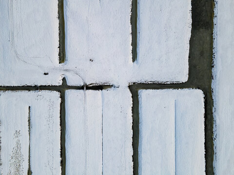 Aerial view of stark white rectangular shapes intersected by dark lines create a minimalist, geometric pattern from above, Delft, South Holland, Netherlands.