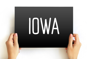 IOWA word centered on a rectangular card held by both hands. Simple and versatile concept image for geography, U.S. states, tourism, education, or design projects